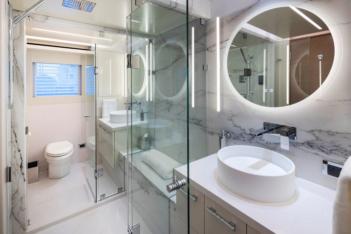 The yacht's bathroom features modern fixtures and a luxurious marble design. aboard WESTPORT 117 / 35M Yacht for Sale