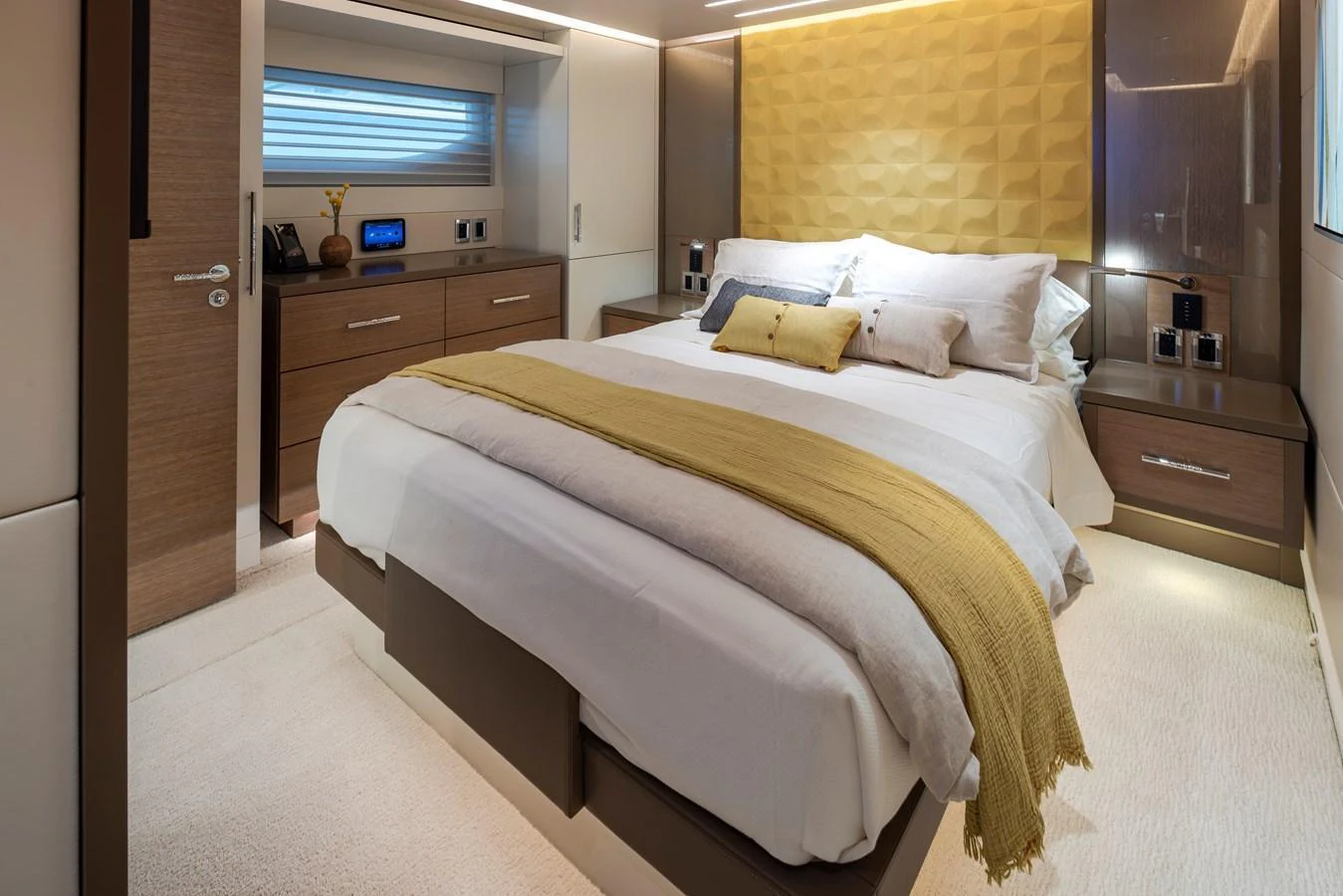 The stateroom features a luxurious bed with elegant bedding and modern decor. aboard WESTPORT 117 / 35M Yacht for Sale
