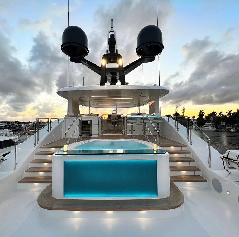 The sundeck features a luxurious pool with ambient lighting and a spacious lounging area. aboard WESTPORT 117 / 35M Yacht for Sale