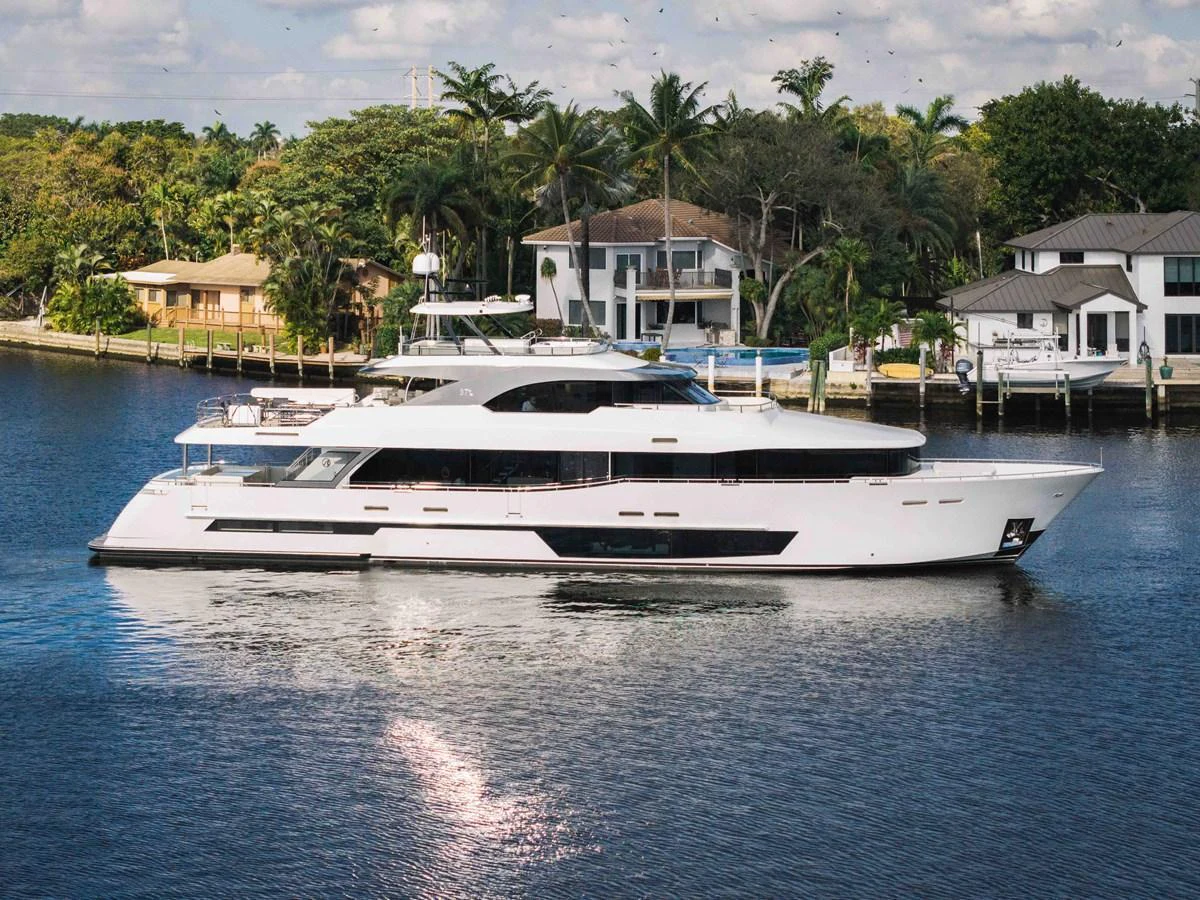 A sleek and modern yacht is cruising along a serene waterfront, showcasing its elegant design and spacious decks. aboard OCEAN ALEXANDER 37L Yacht for Sale