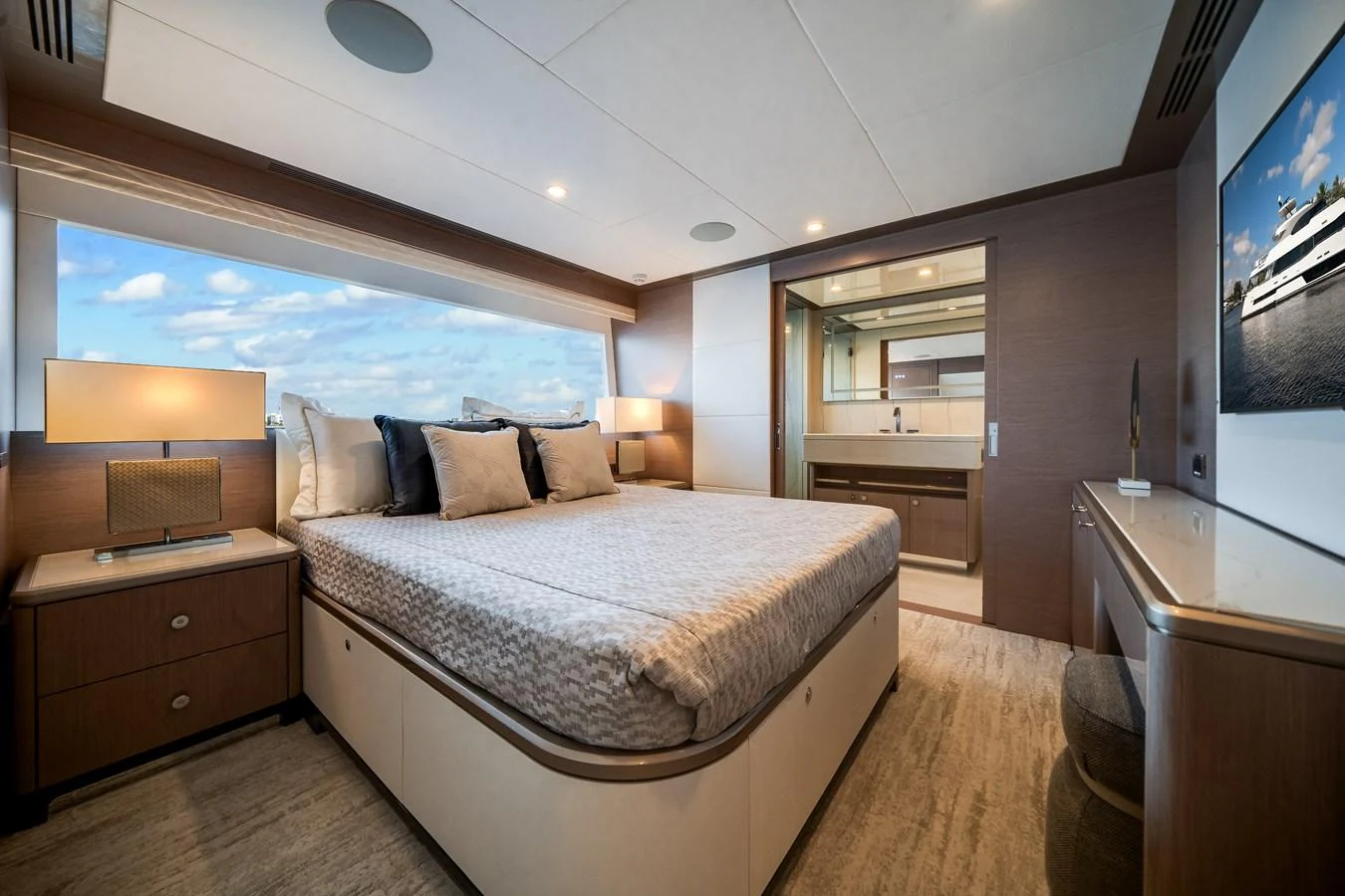 The master stateroom features a spacious bed, modern decor, and an ensuite bathroom with luxurious amenities. aboard OCEAN ALEXANDER 37L Yacht for Sale