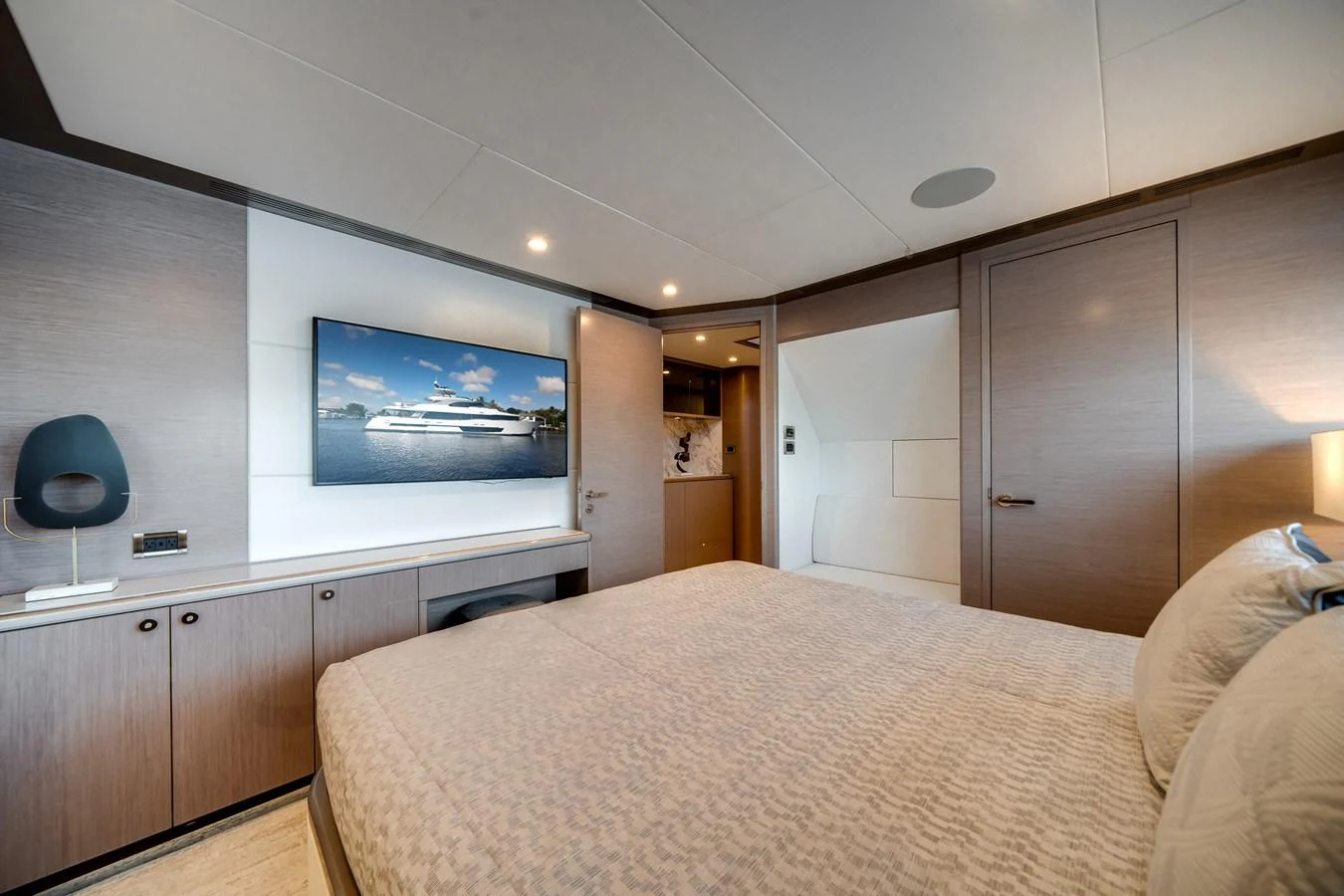 A luxurious stateroom featuring a large bed, modern furnishings, and a flat-screen TV. aboard OCEAN ALEXANDER 37L Yacht for Sale