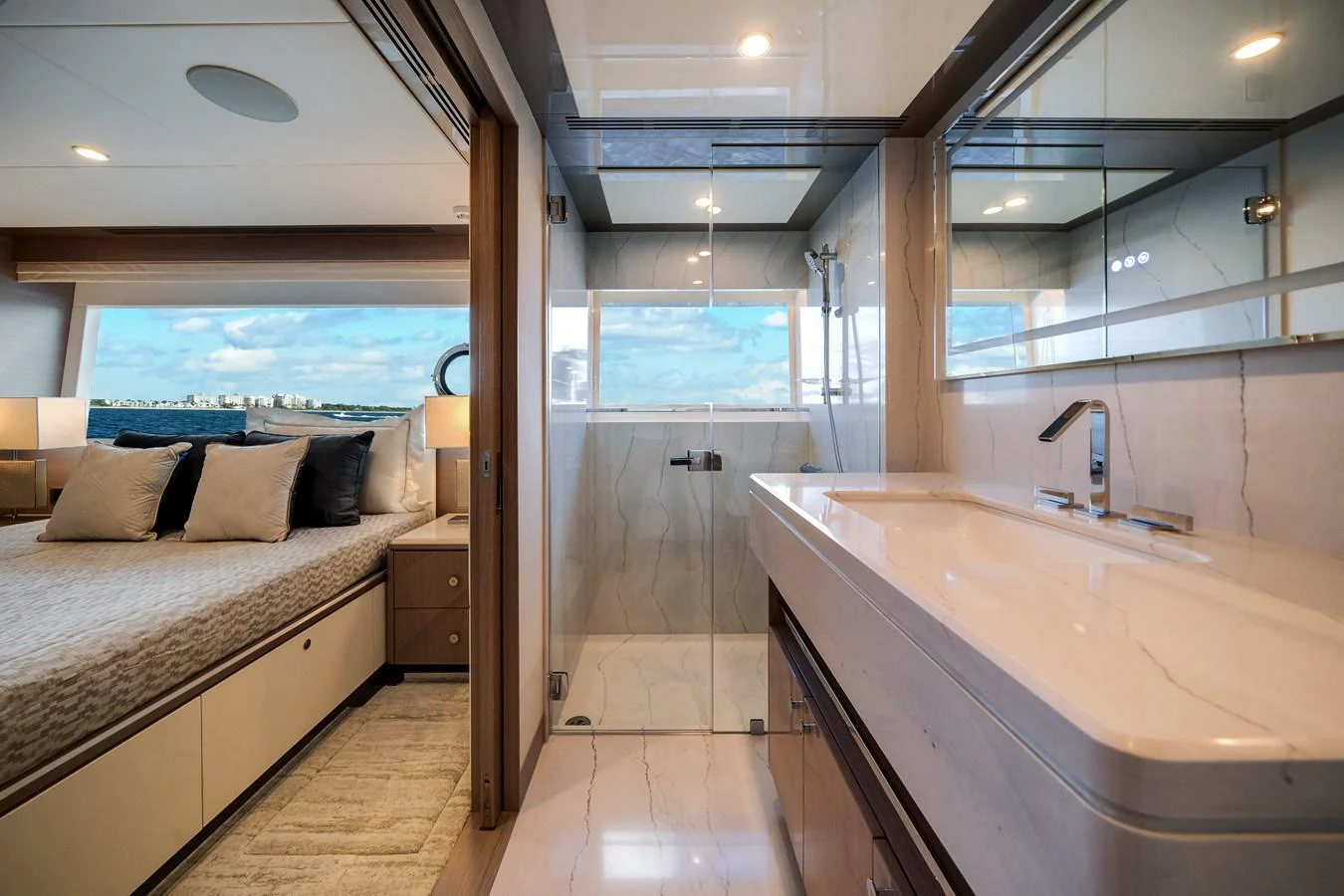 The image showcases a luxurious stateroom with an ensuite bathroom, featuring elegant finishes and a serene ambiance. aboard OCEAN ALEXANDER 37L Yacht for Sale