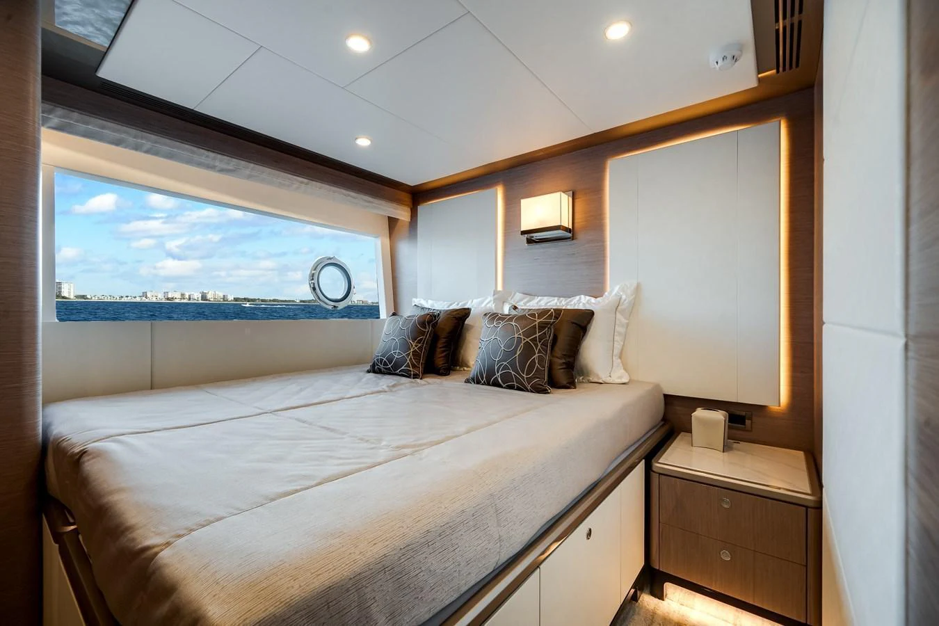 The stateroom features a large bed with elegant bedding and a scenic window view. aboard OCEAN ALEXANDER 37L Yacht for Sale