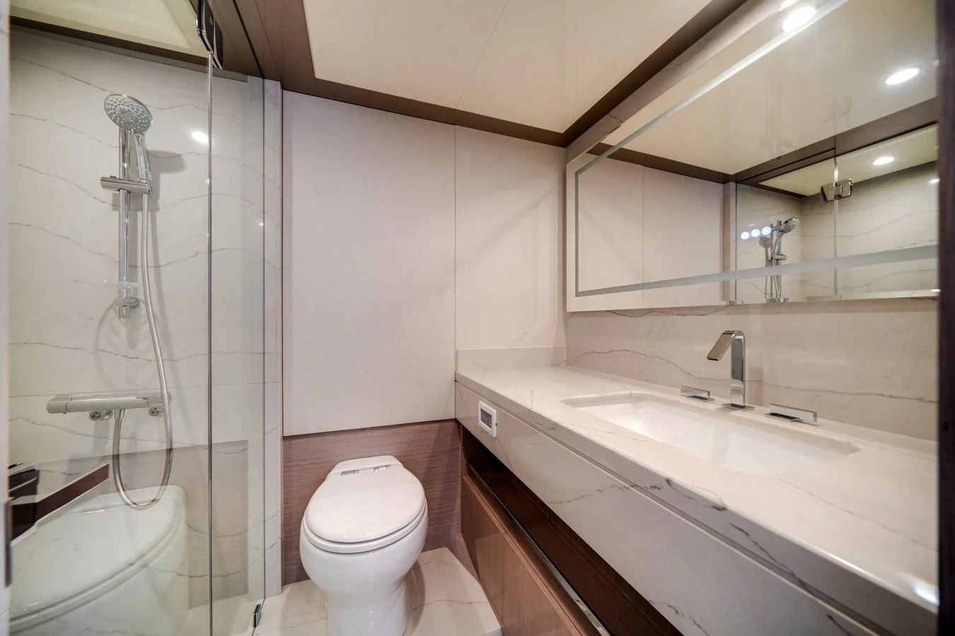 A sleek and modern yacht bathroom featuring a spacious shower and elegant fixtures. aboard OCEAN ALEXANDER 37L Yacht for Sale