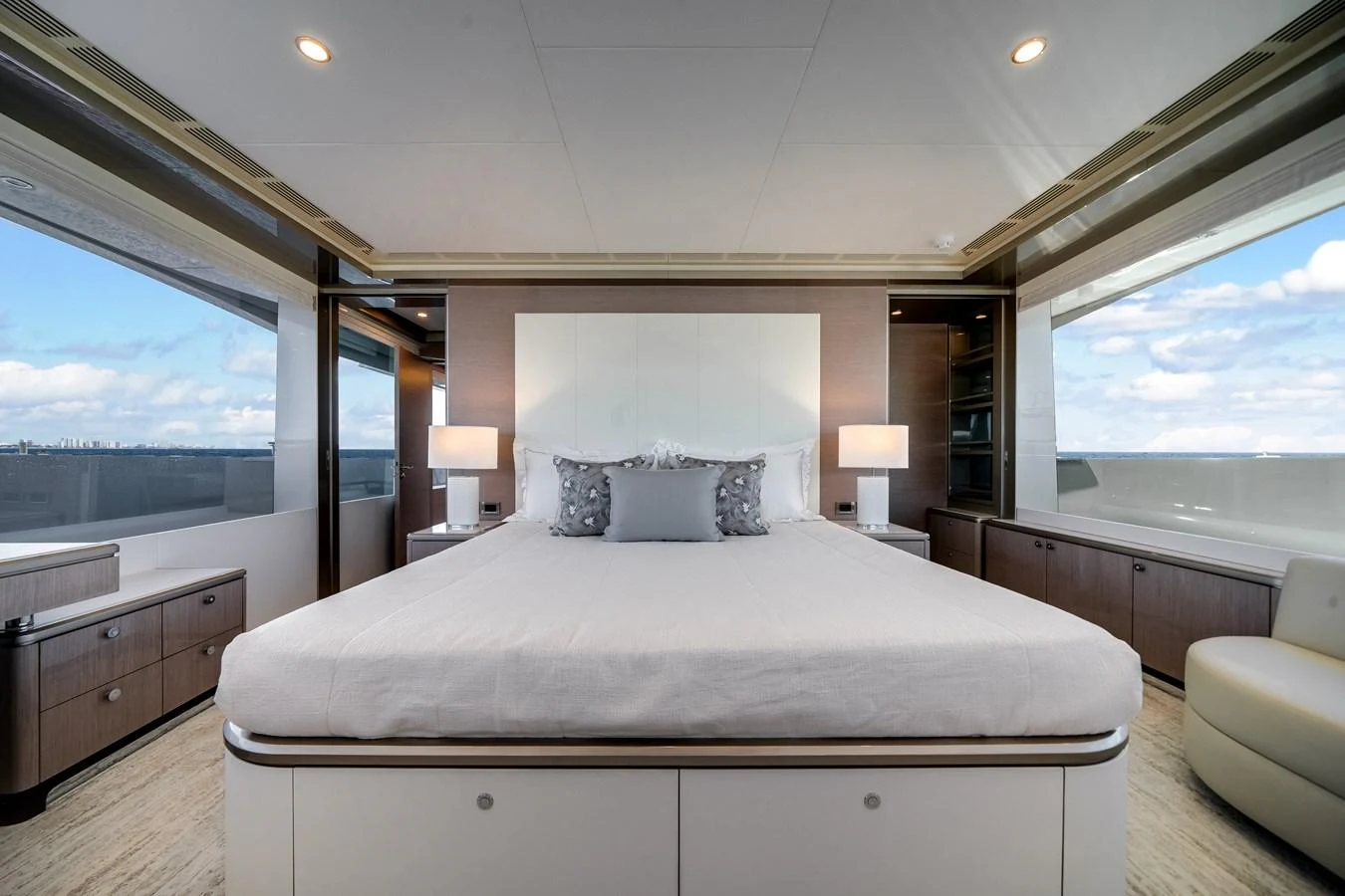 The master stateroom features a luxurious bed with panoramic windows offering stunning views. aboard OCEAN ALEXANDER 37L Yacht for Sale