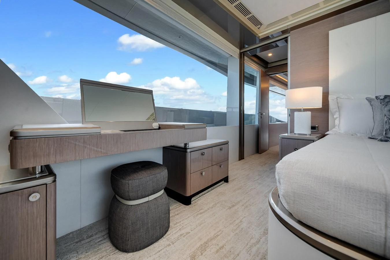 The stateroom features a stylish vanity, plush seating, and expansive windows for natural light. aboard OCEAN ALEXANDER 37L Yacht for Sale