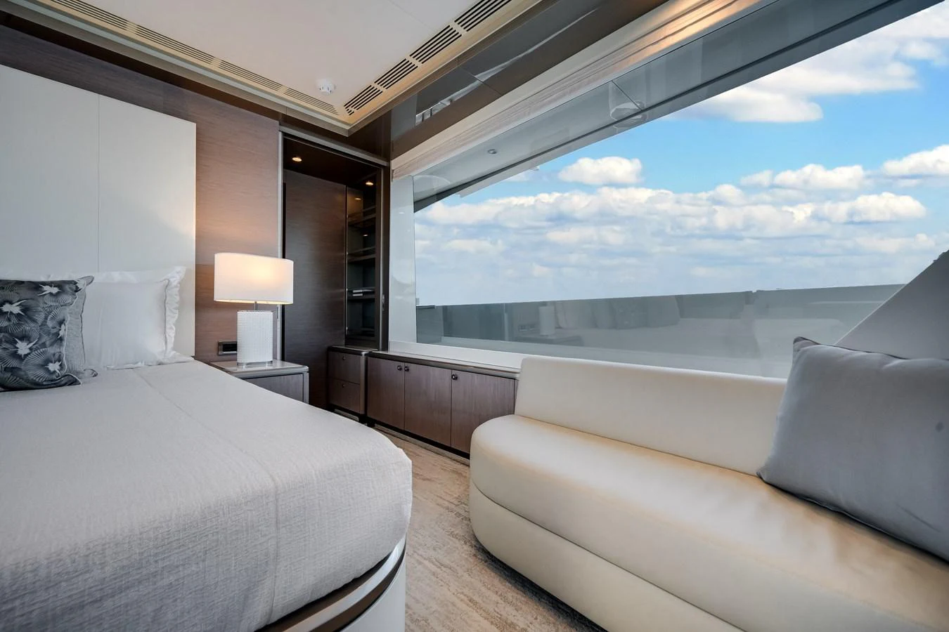 The stateroom features a large window with a stunning view, a comfortable bed, and a cozy seating area. aboard OCEAN ALEXANDER 37L Yacht for Sale
