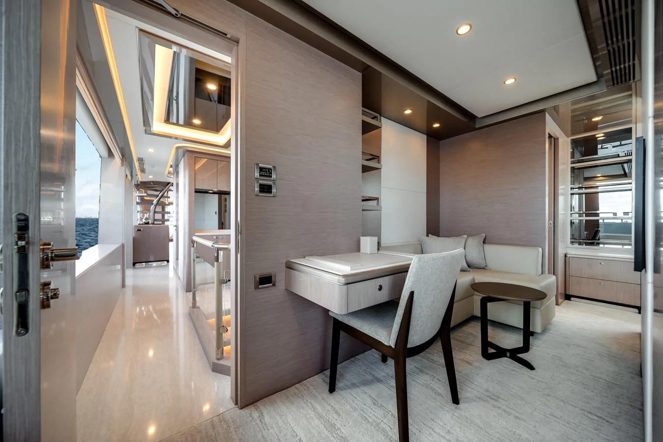 The yacht's interior features a modern and elegant seating area with a desk and comfortable furnishings. aboard OCEAN ALEXANDER 37L Yacht for Sale