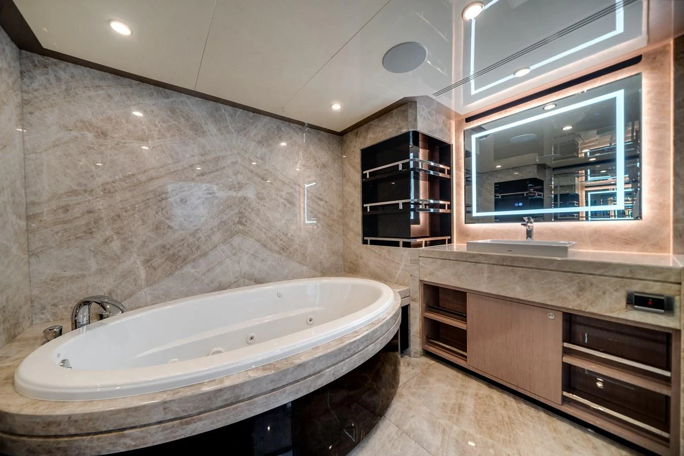The luxurious bathroom features a large soaking tub and modern vanity with an illuminated mirror. aboard OCEAN ALEXANDER 37L Yacht for Sale