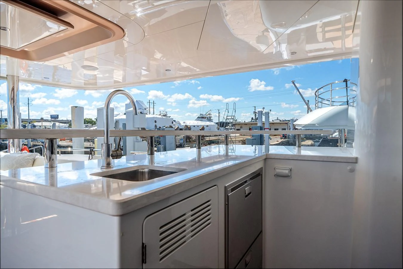 The yacht's galley features modern appliances and a sleek design with a view of the marina. aboard OCEAN ALEXANDER 37L Yacht for Sale