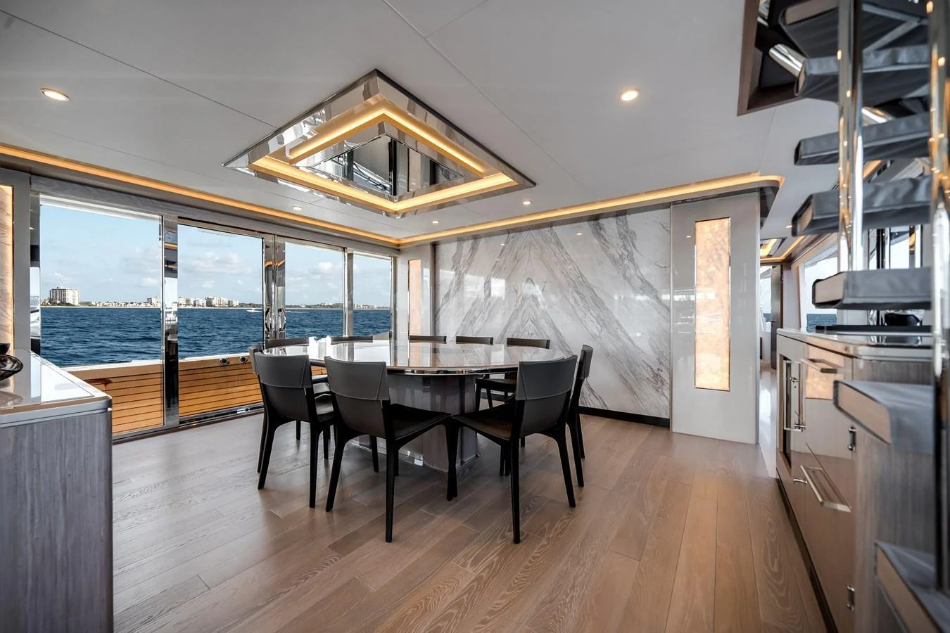 The yacht's dining area features a modern design with a stunning view of the sea. aboard OCEAN ALEXANDER 37L Yacht for Sale