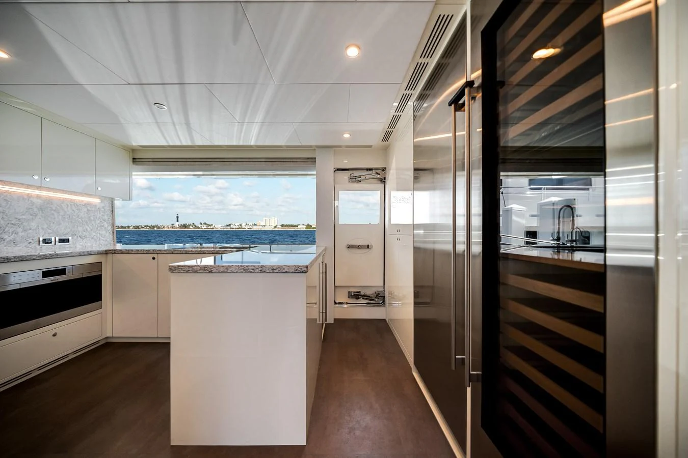 The yacht's galley features modern appliances and a sleek design with a view of the water. aboard OCEAN ALEXANDER 37L Yacht for Sale