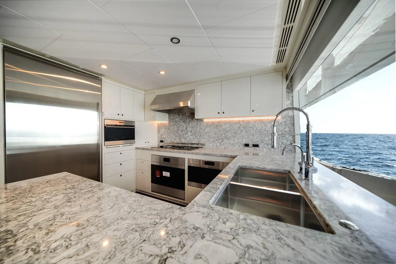 The yacht's galley features modern appliances and a stunning ocean view. aboard OCEAN ALEXANDER 37L Yacht for Sale