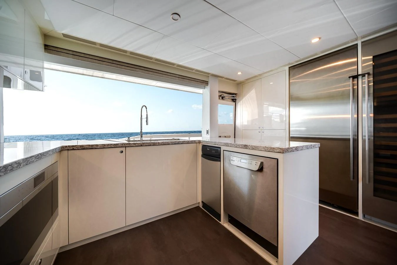 The modern galley features sleek cabinetry, stainless steel appliances, and a stunning ocean view. aboard OCEAN ALEXANDER 37L Yacht for Sale