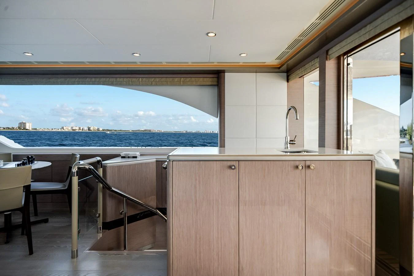 A stylish interior space with a view of the ocean through large windows. aboard OCEAN ALEXANDER 37L Yacht for Sale