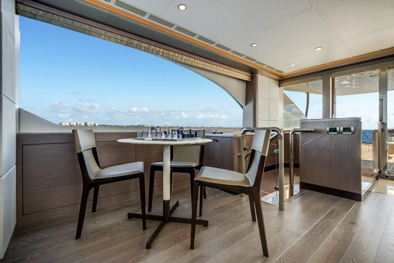 The yacht's dining area offers a serene setting with a view of the sea. aboard OCEAN ALEXANDER 37L Yacht for Sale