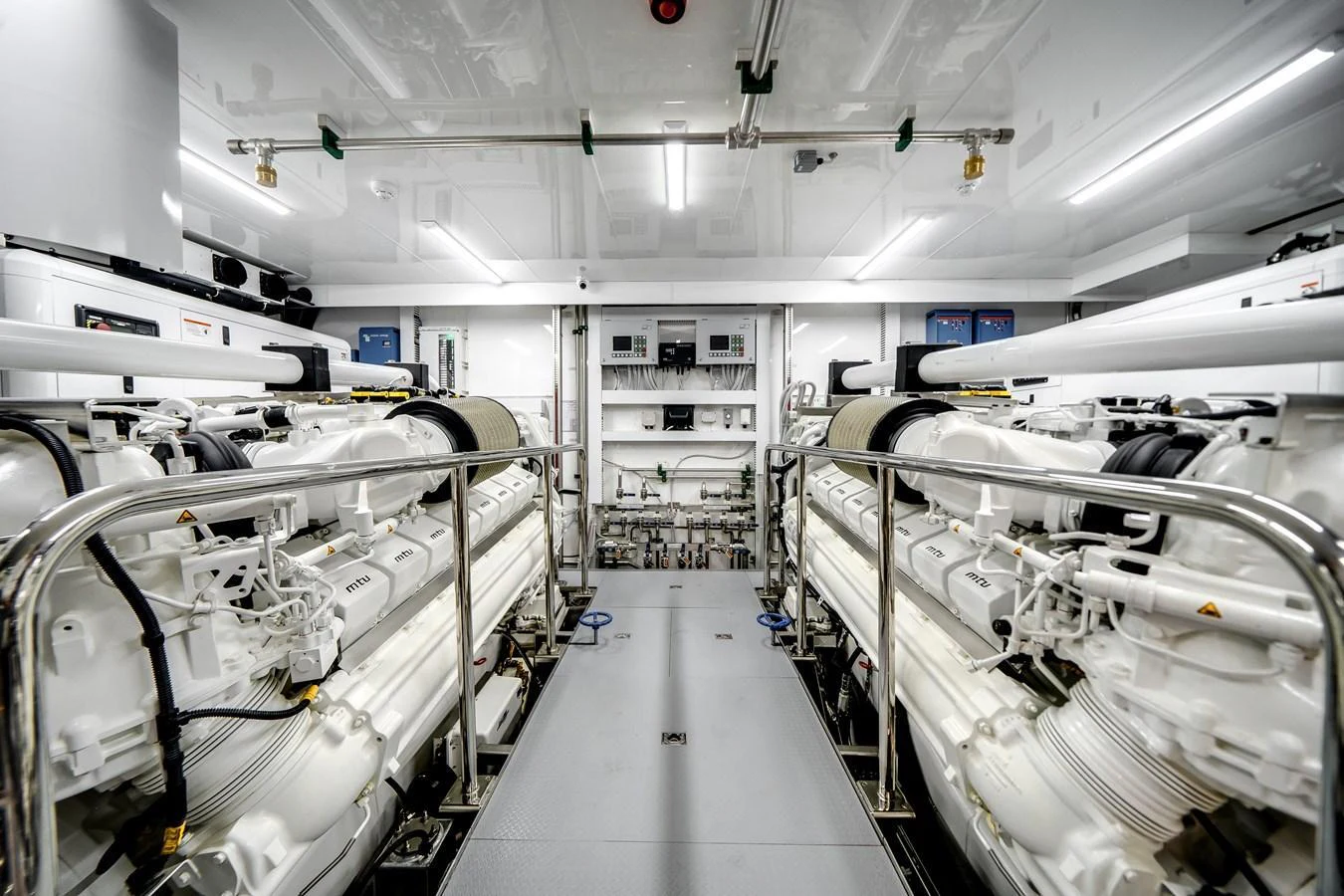 The yacht's engine room showcases powerful machinery and a clean, organized layout. aboard OCEAN ALEXANDER 37L Yacht for Sale