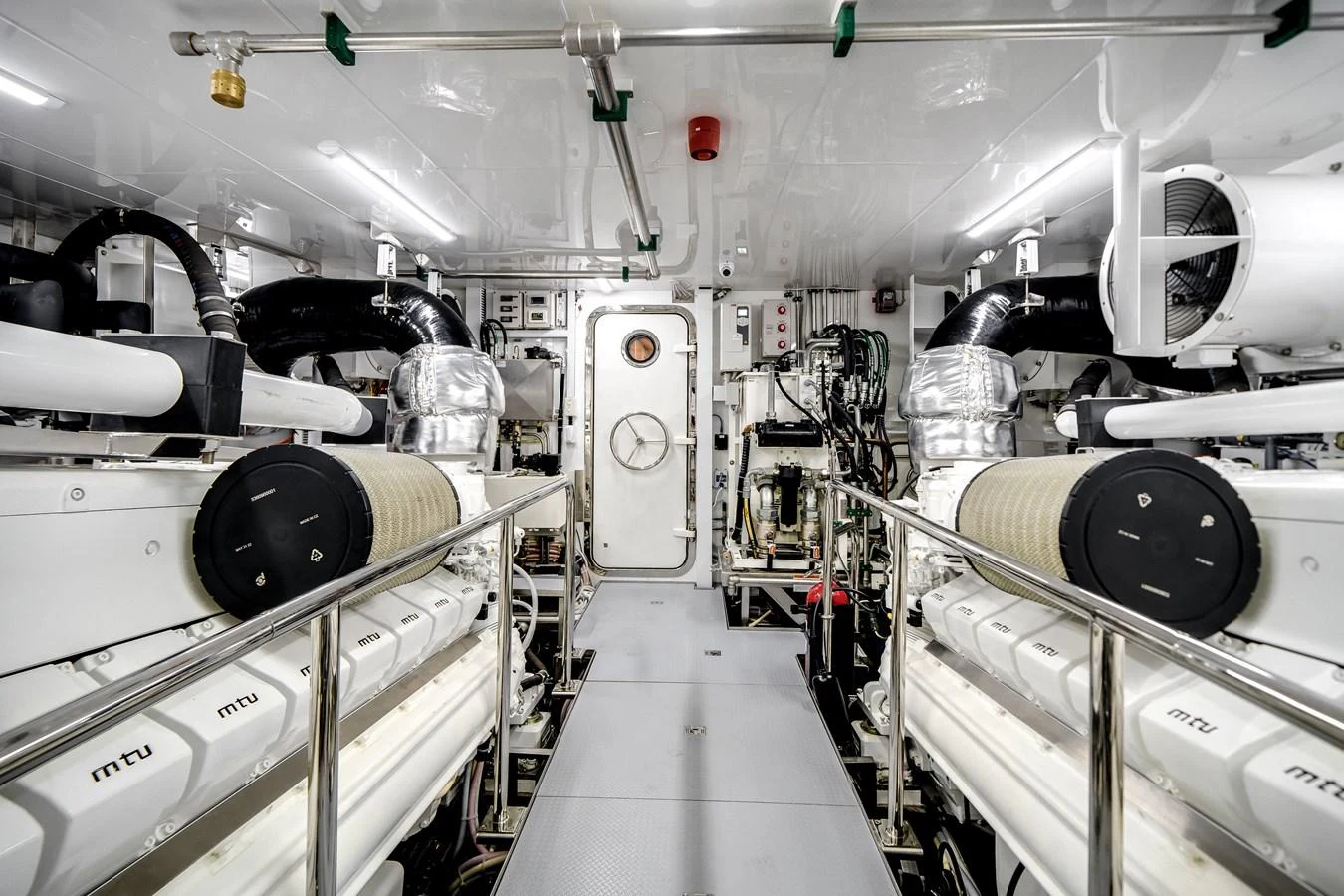 The yacht's engine room showcases powerful machinery and a clean, organized layout. aboard OCEAN ALEXANDER 37L Yacht for Sale