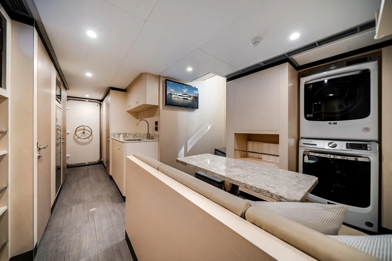 The galley features modern appliances and a cozy dining area with a marble table. aboard OCEAN ALEXANDER 37L Yacht for Sale