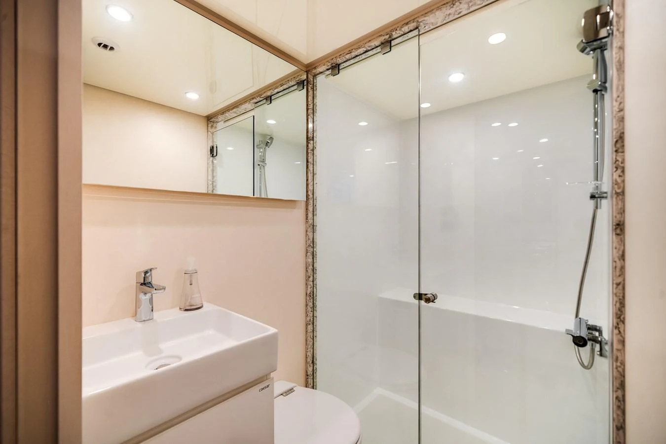 The yacht's bathroom features a sleek, modern design with a glass-enclosed shower and contemporary fixtures. aboard OCEAN ALEXANDER 37L Yacht for Sale