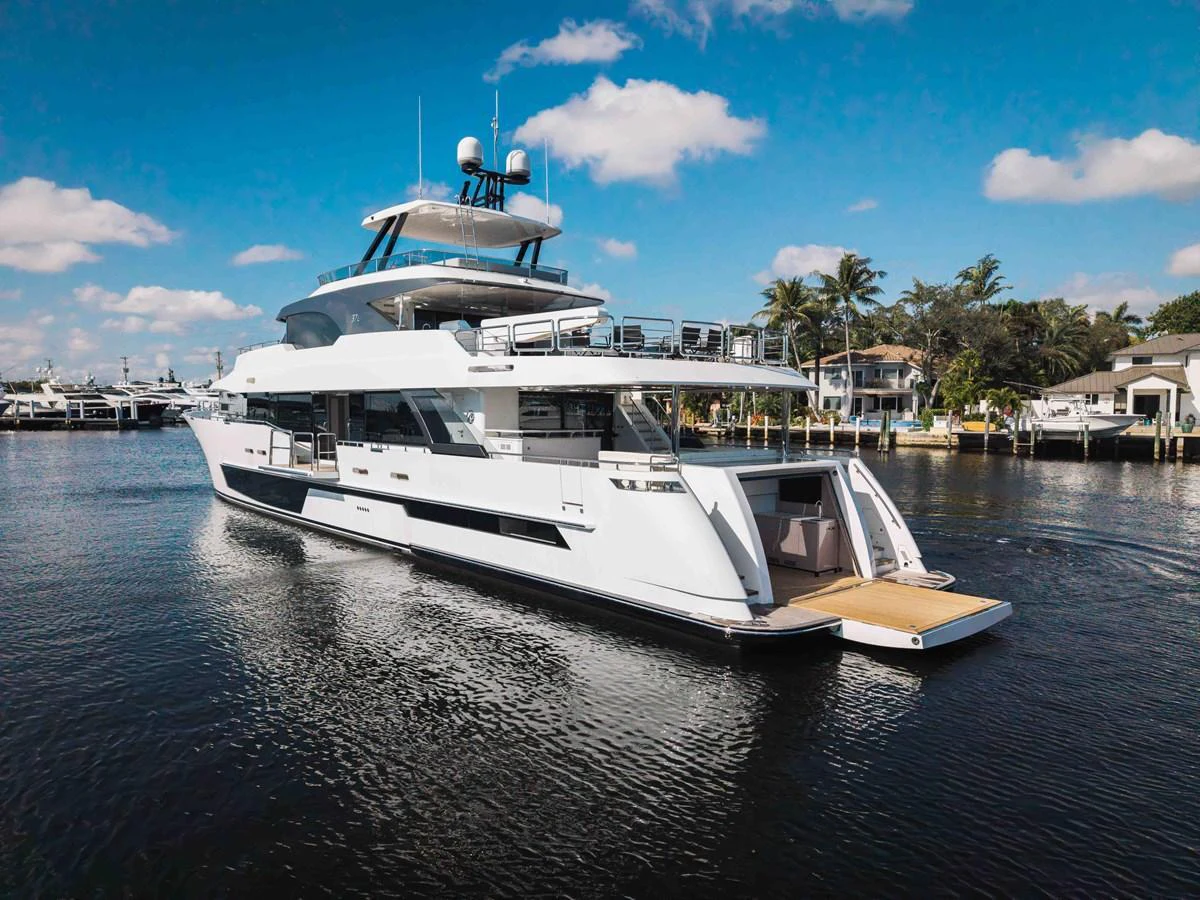 A sleek and modern yacht is cruising on calm waters under a clear blue sky. aboard OCEAN ALEXANDER 37L Yacht for Sale