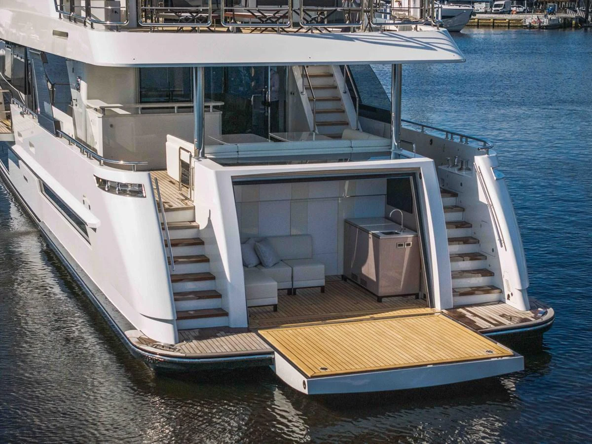 The yacht's aft deck features a spacious lounging area with easy water access. aboard OCEAN ALEXANDER 37L Yacht for Sale