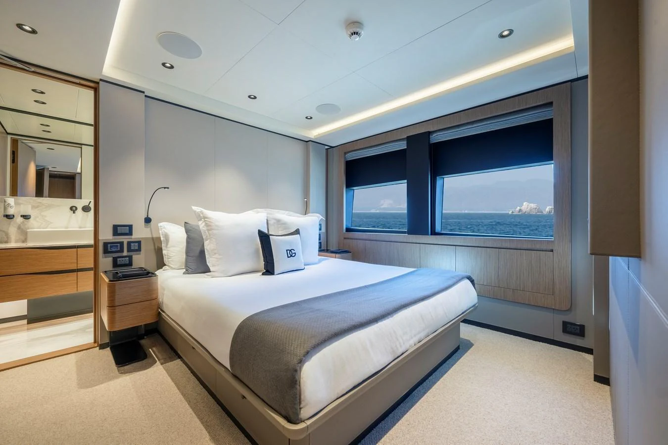 A luxurious stateroom with a large bed and ocean views through the windows. aboard SPRITZ 116 Yacht for Sale
