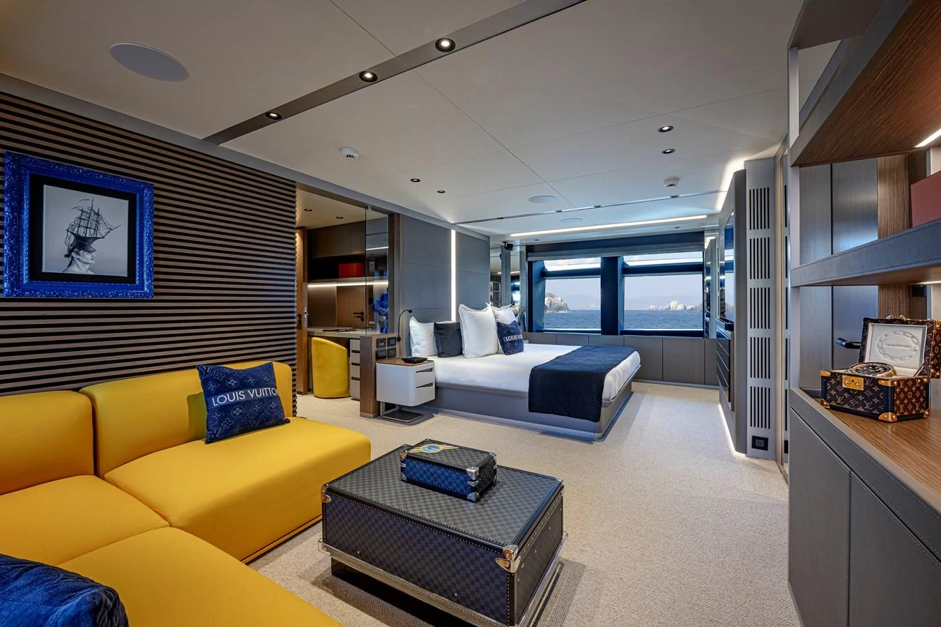 The luxurious stateroom features a spacious seating area and a large bed with ocean views. aboard SPRITZ 116 Yacht for Sale