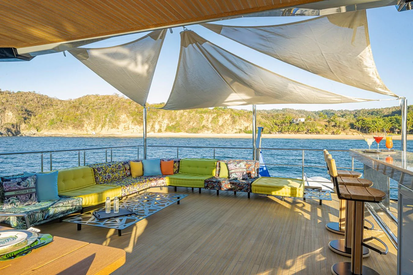 The aft deck offers a spacious and inviting outdoor lounge area with comfortable seating and scenic views. aboard SPRITZ 116 Yacht for Sale
