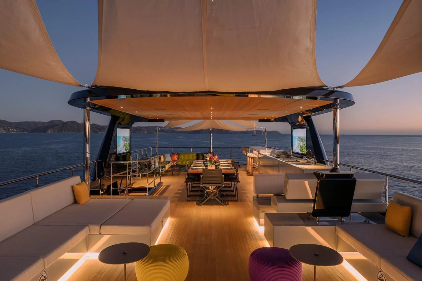 The sundeck offers a luxurious open-air lounge area with ample seating and stunning ocean views. aboard SPRITZ 116 Yacht for Sale