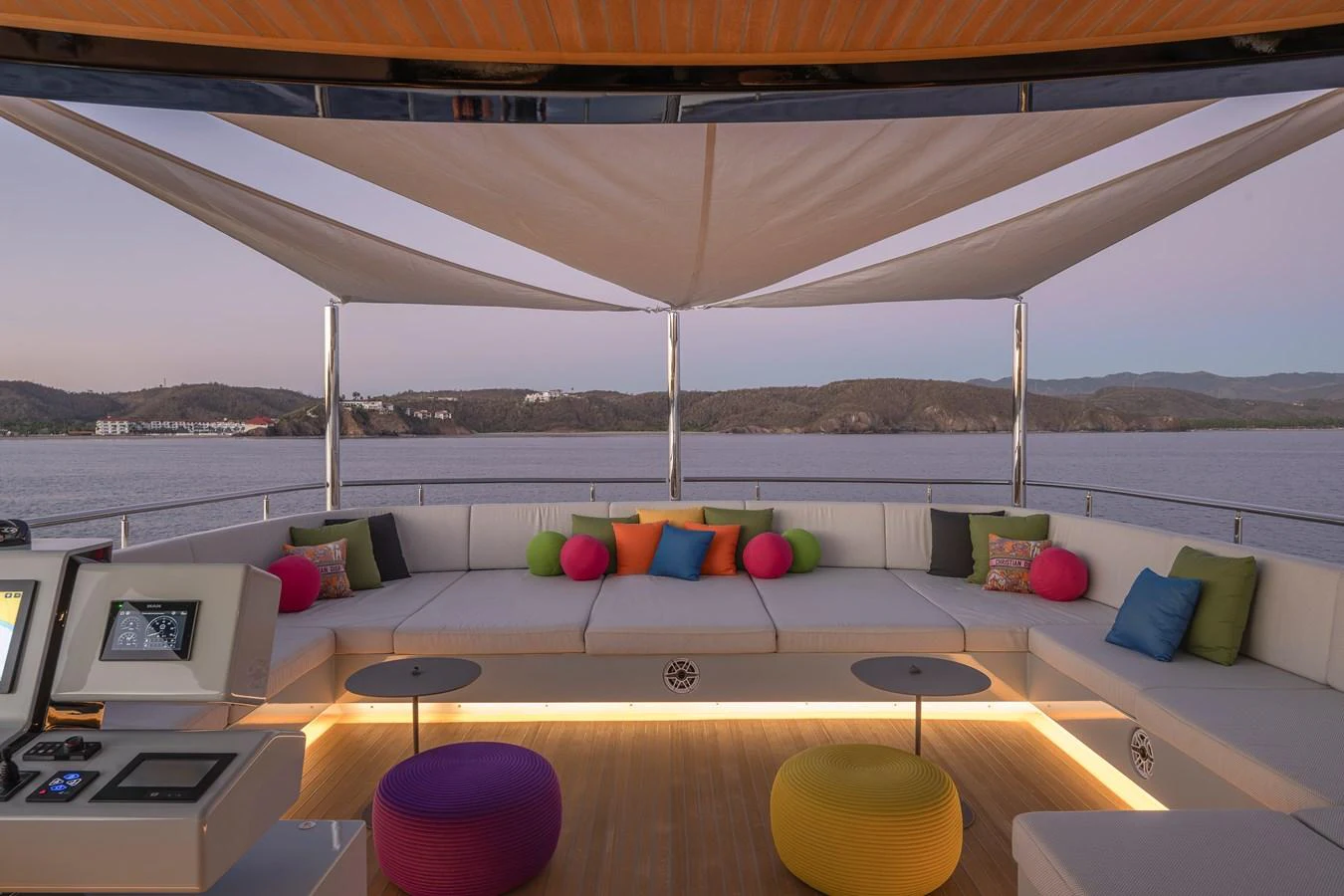 The sundeck features a spacious seating area with colorful cushions and a canopy for shade, offering a perfect spot to relax and enjoy the view. aboard SPRITZ 116 Yacht for Sale