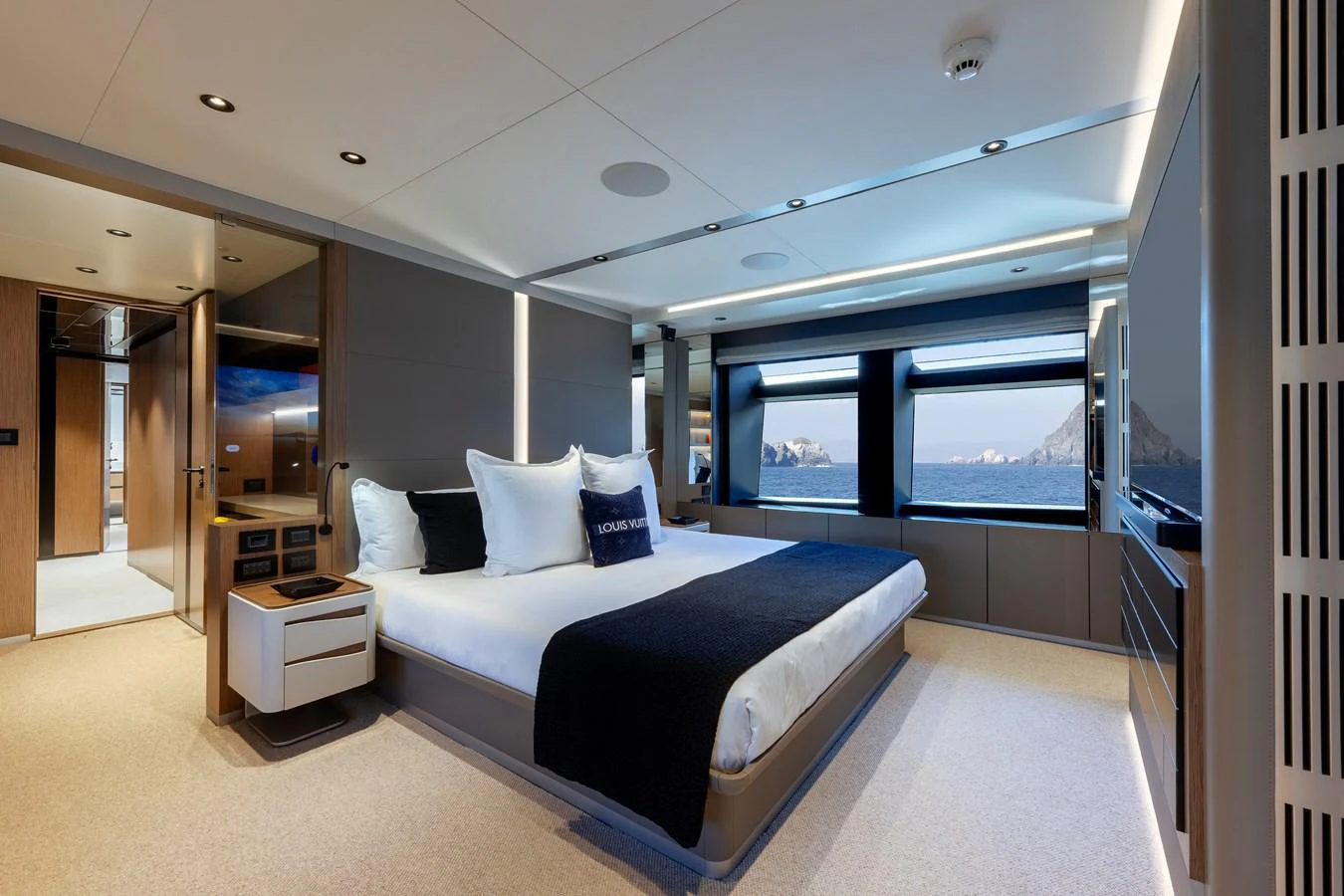 The master stateroom features a luxurious bed with stunning sea views through large windows. aboard SPRITZ 116 Yacht for Sale
