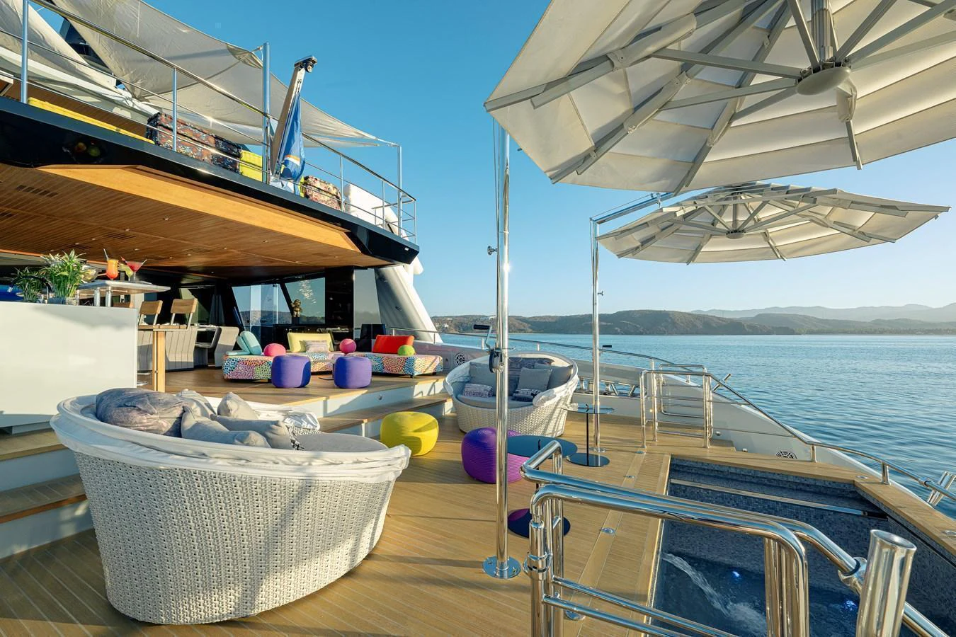 The aft deck offers a luxurious outdoor lounging area with comfortable seating and stunning views. aboard SPRITZ 116 Yacht for Sale