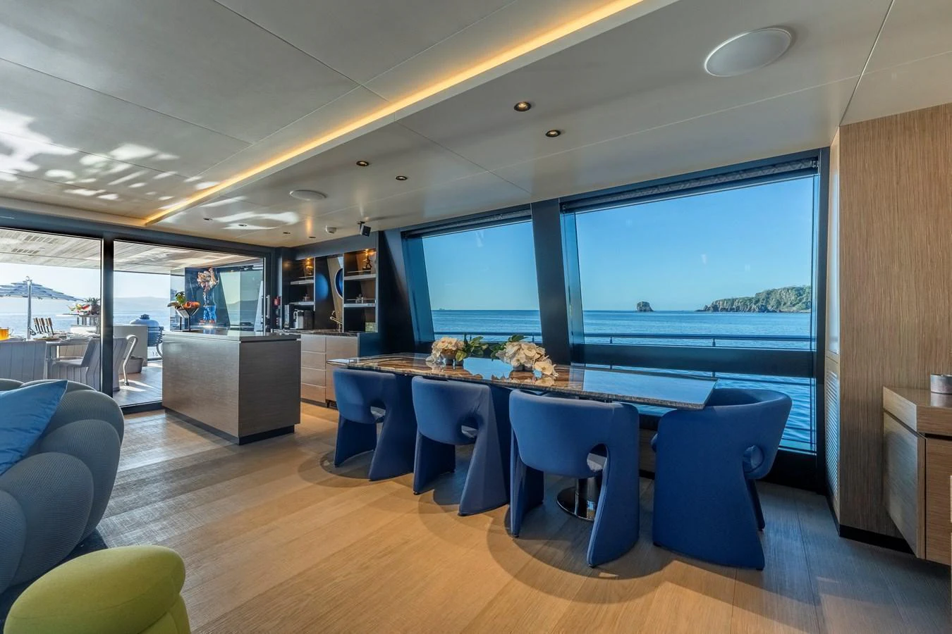The yacht's dining area features a modern design with large windows offering stunning ocean views. aboard SPRITZ 116 Yacht for Sale
