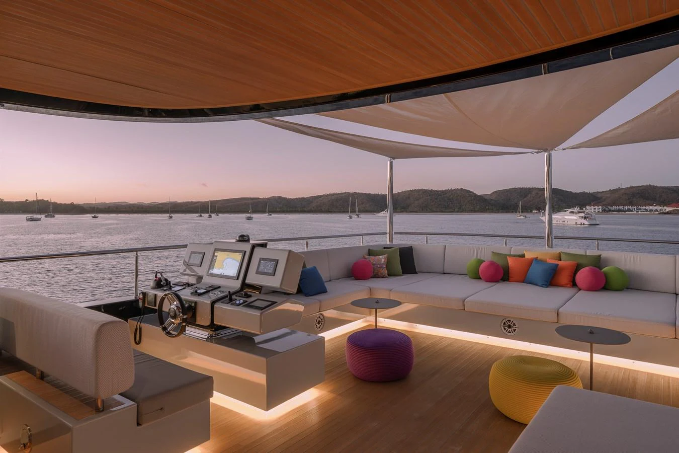 The flybridge features a spacious seating area with colorful cushions and a panoramic view of the water. aboard SPRITZ 116 Yacht for Sale