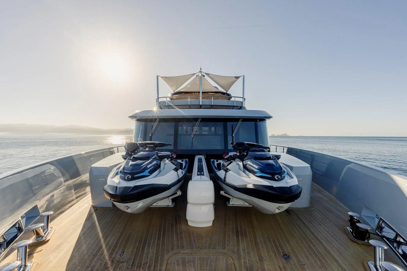 The foredeck of the yacht features two jet skis and a spacious lounging area under the sun. aboard H2O - SPRITZ 116 Yacht for Sale