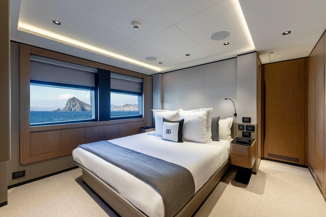 A luxurious stateroom with a large bed and scenic ocean views through the windows. aboard H2O - SPRITZ 116 Yacht for Sale