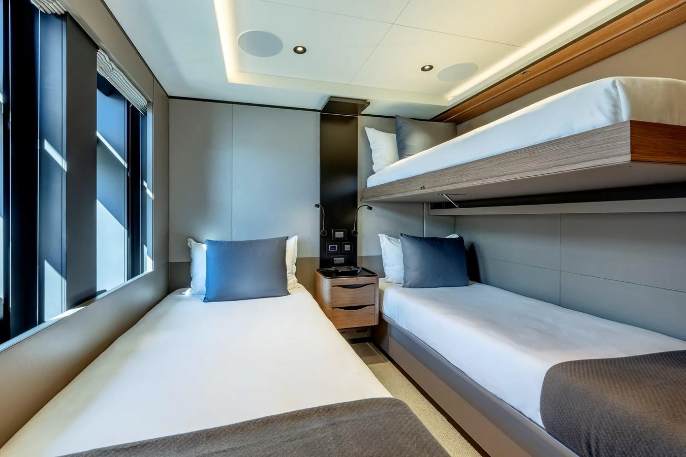 The guest cabin features modern bunk beds and sleek design elements for a comfortable stay. aboard H2O - SPRITZ 116 Yacht for Sale