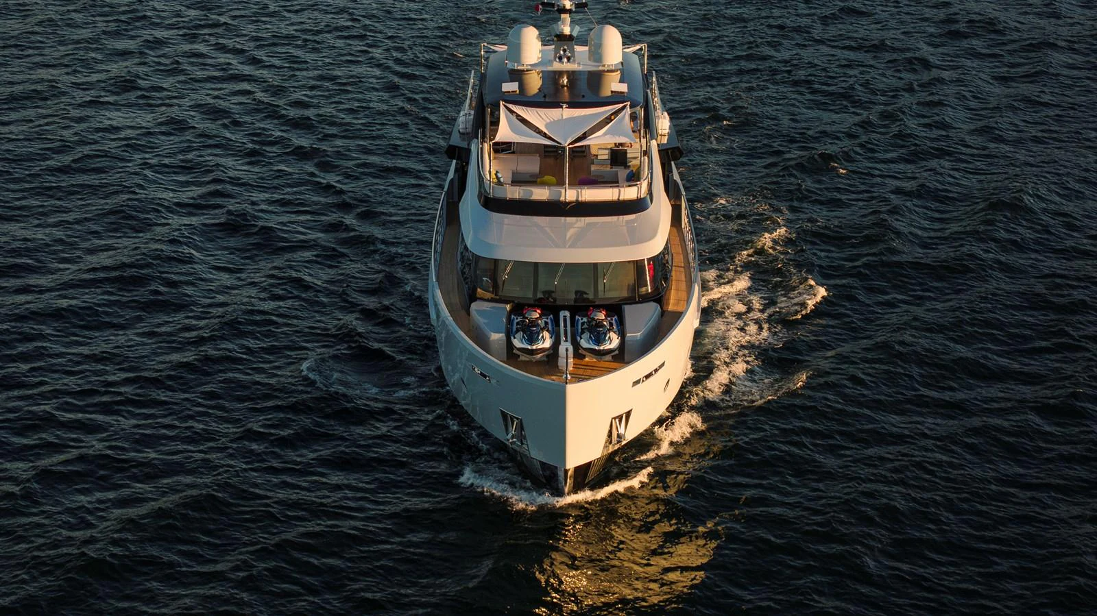 A luxurious yacht cruises through the water, showcasing its elegant design and spacious decks. aboard H2O - SPRITZ 116 Yacht for Sale