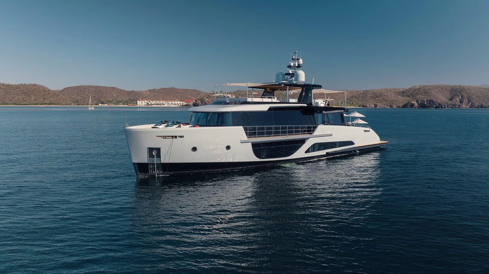 A sleek and modern yacht glides gracefully on calm waters with a scenic backdrop. aboard H2O - SPRITZ 116 Yacht for Sale