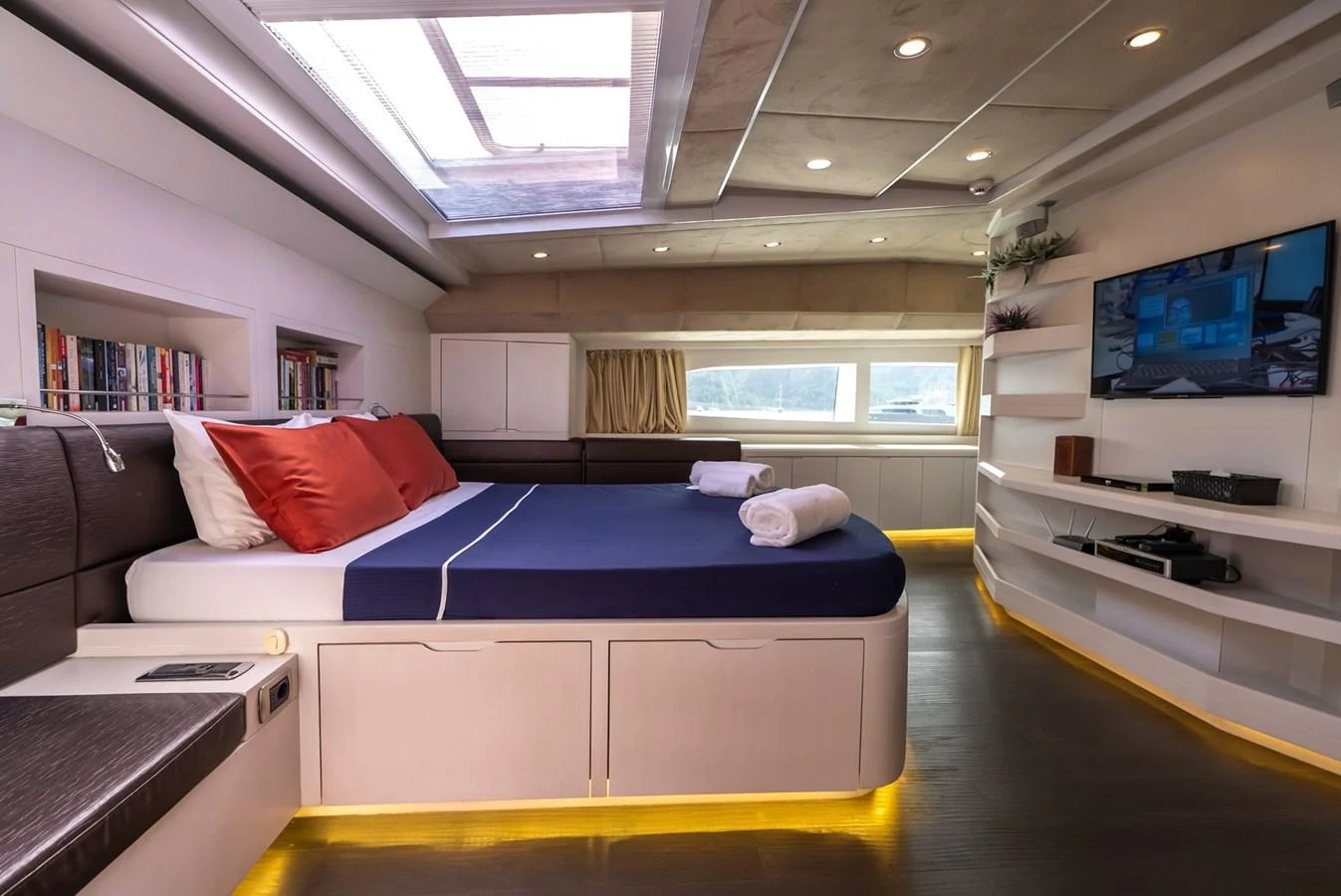 A luxurious stateroom featuring a comfortable bed, modern entertainment system, and ample natural light. aboard JAFE TICA Yacht for Sale