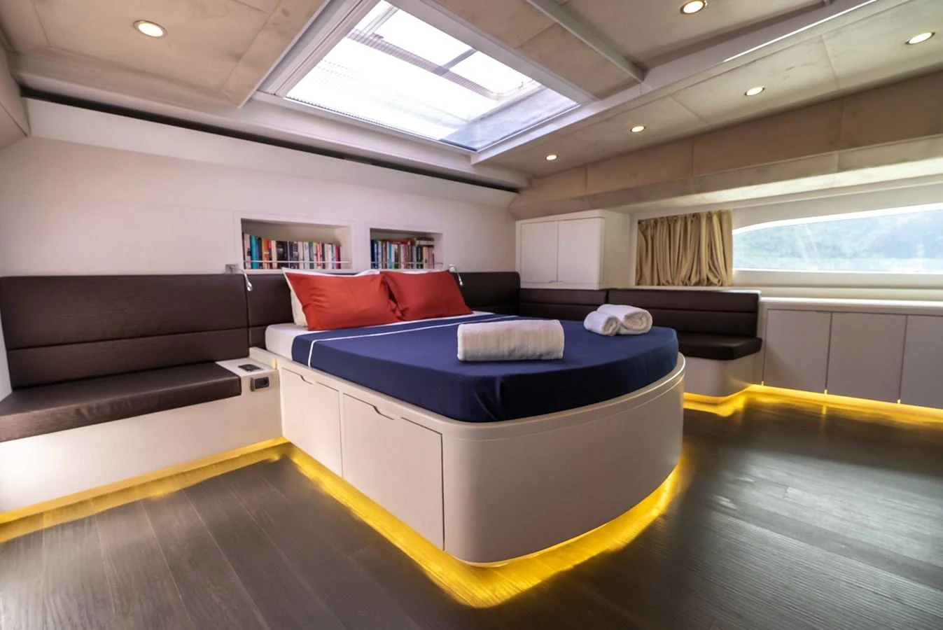 The master stateroom features a spacious bed, ambient lighting, and a skylight for natural illumination. aboard JAFE TICA Yacht for Sale