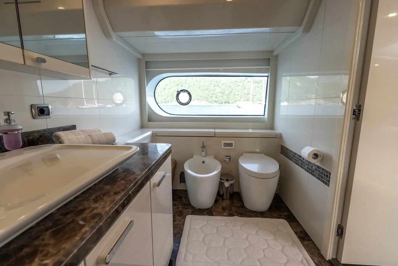 The yacht's bathroom features modern fixtures and a large window for natural light. aboard JAFE TICA Yacht for Sale
