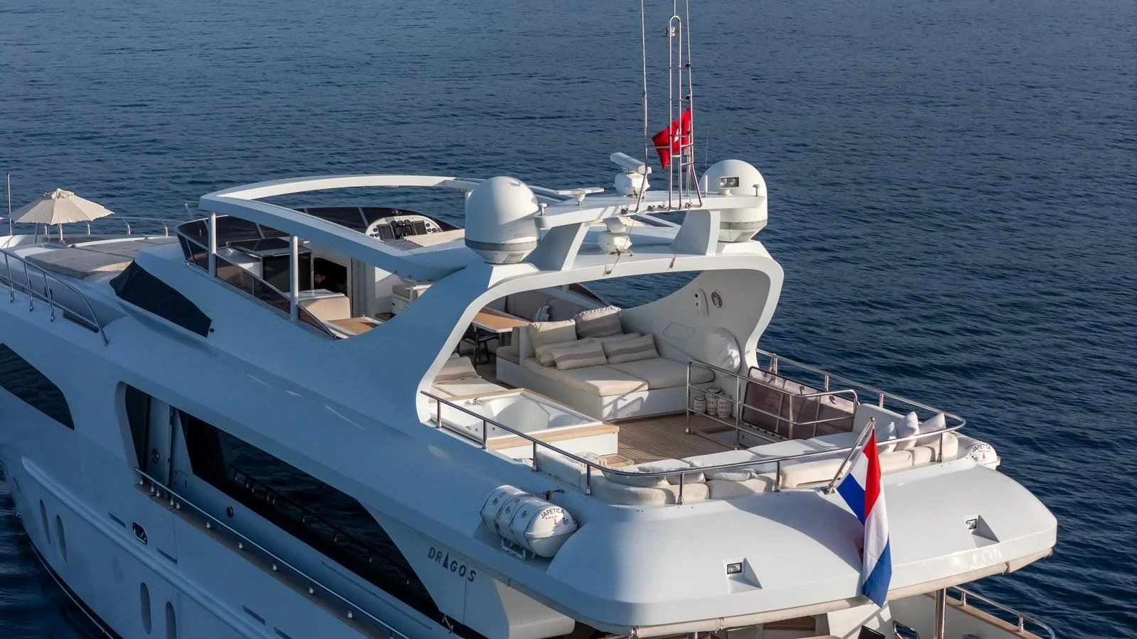 The yacht's flybridge offers an expansive and luxurious outdoor lounging area with stunning sea views. aboard JAFE TICA Yacht for Sale