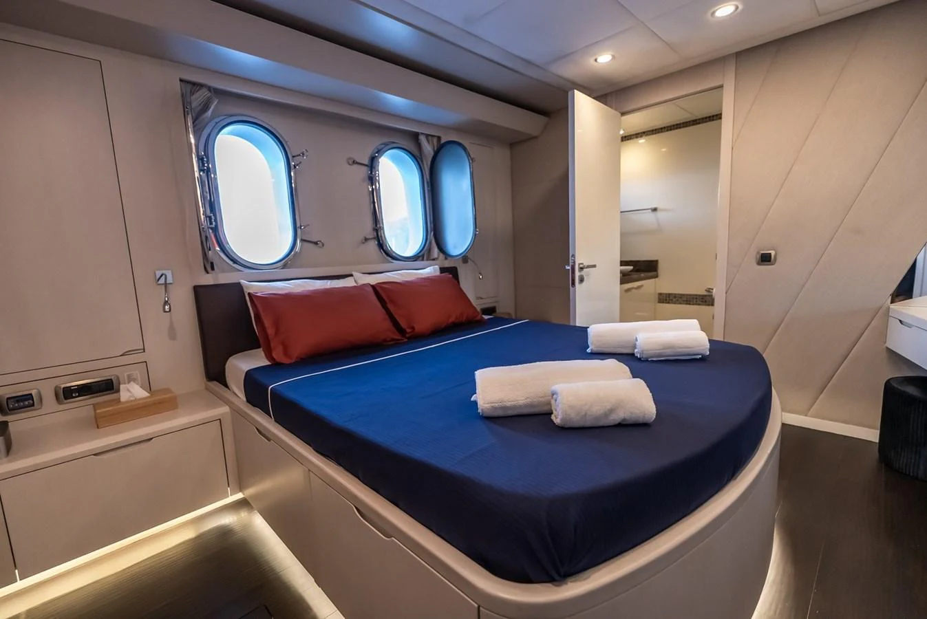 The stateroom features a cozy bed with elegant linens and ample natural light from the portholes. aboard JAFE TICA Yacht for Sale