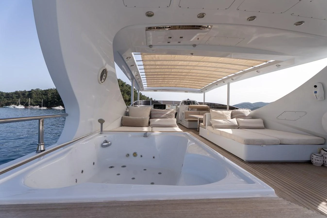 The sundeck features a luxurious jacuzzi and comfortable lounging areas with a stunning view of the water. aboard JAFE TICA Yacht for Sale