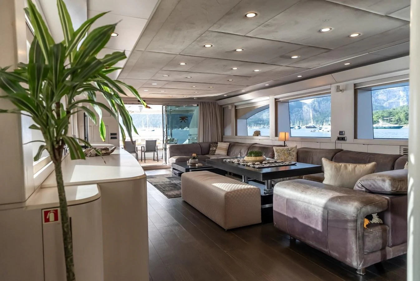 The spacious salon features comfortable seating and large windows with scenic views. aboard JAFE TICA Yacht for Sale