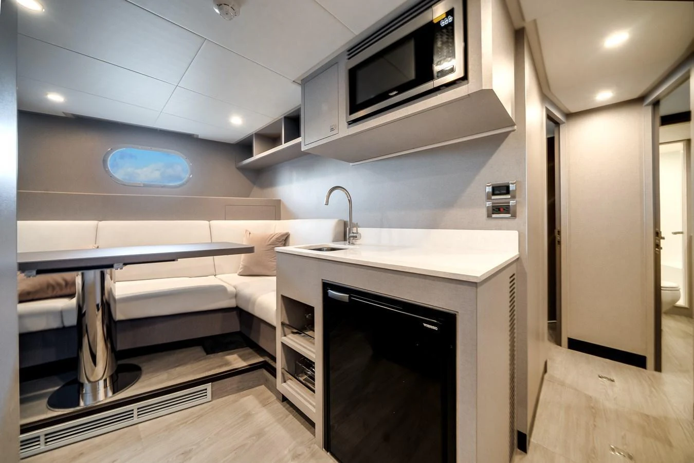 The yacht's galley features a modern kitchenette and a cozy dining area with a sleek design. aboard OCEAN ALEXANDER 44G/01 Yacht for Sale