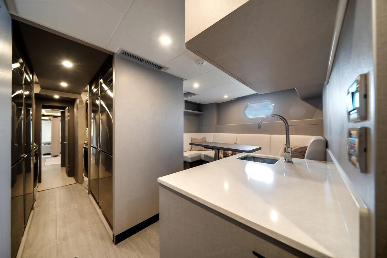 This image showcases a modern galley with sleek finishes and ample seating space. aboard OCEAN ALEXANDER 44G/01 Yacht for Sale